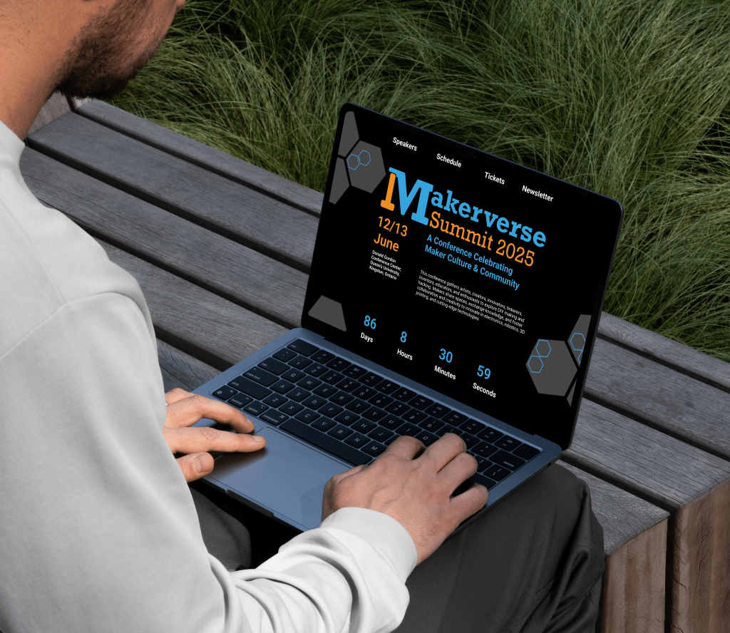 Mockup showing a user viewing the Makerverse Conference website on a laptop